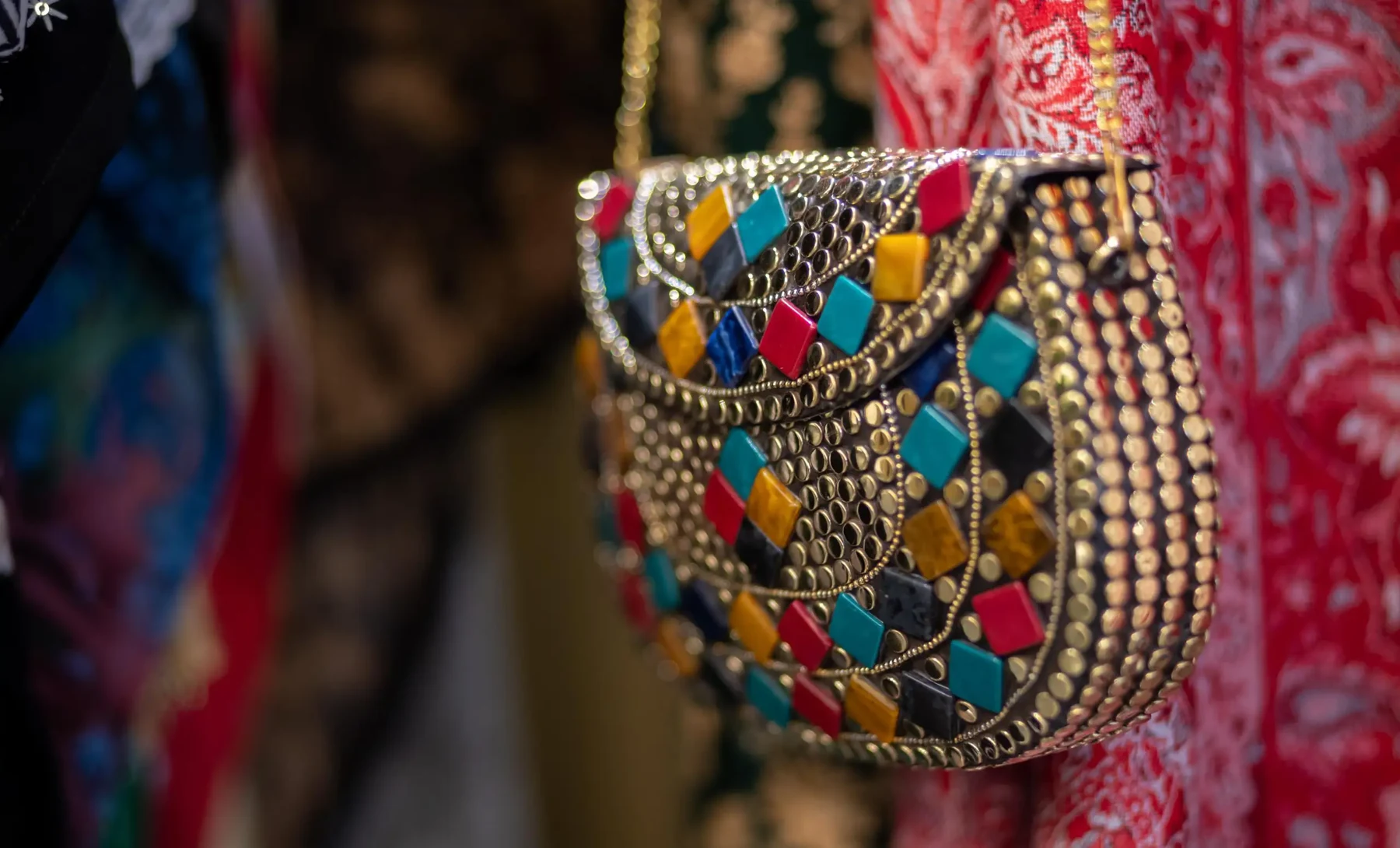 Colourful handcrafted metal handbag against Kashmiri textiles