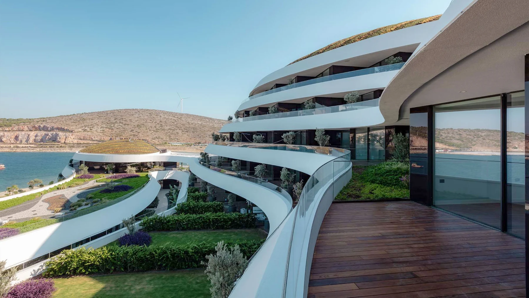 Curved balconies and glass facade of a waterfront building